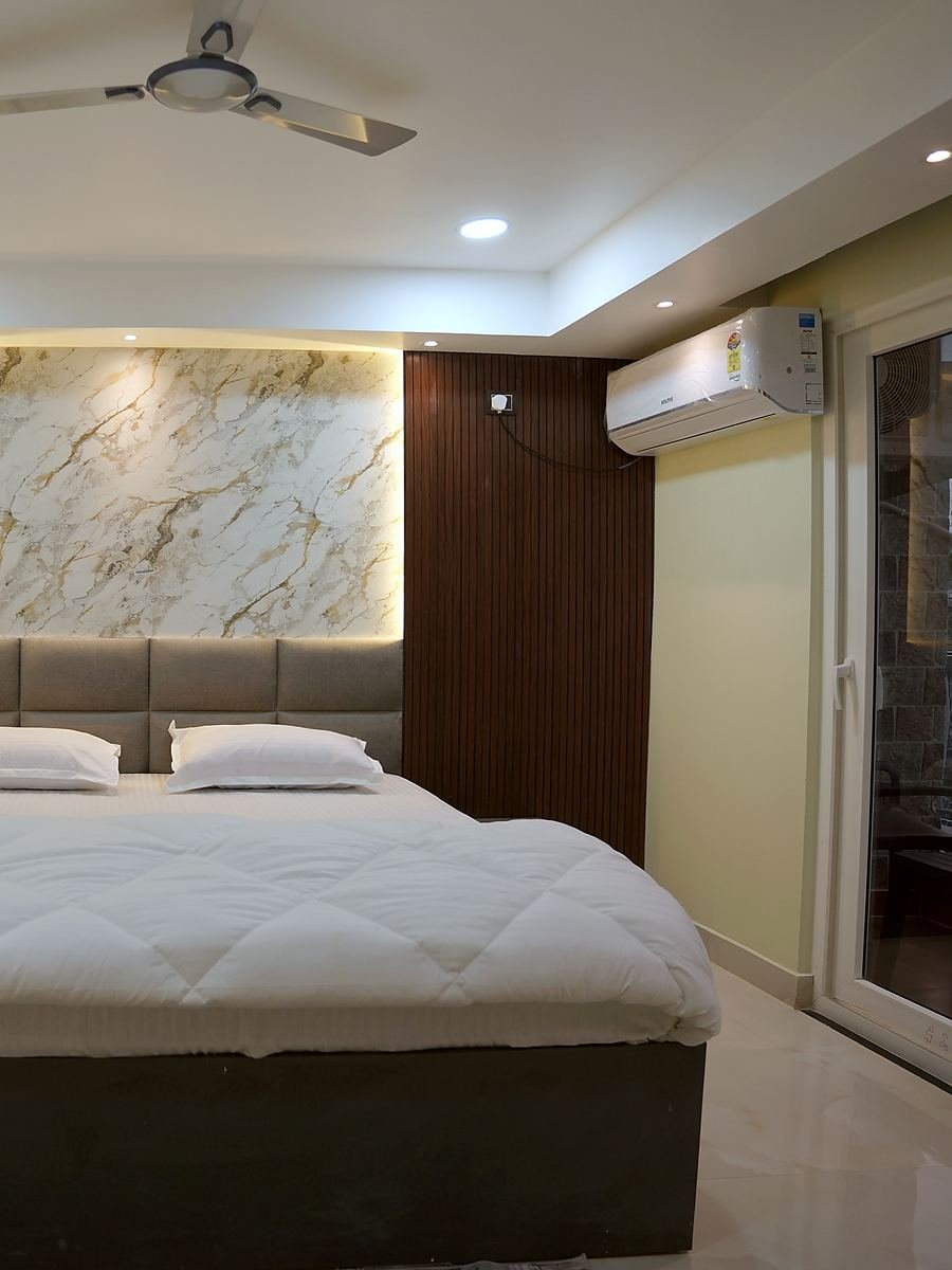 A Deluxe Room looking towards the glazed doors and the light beyond