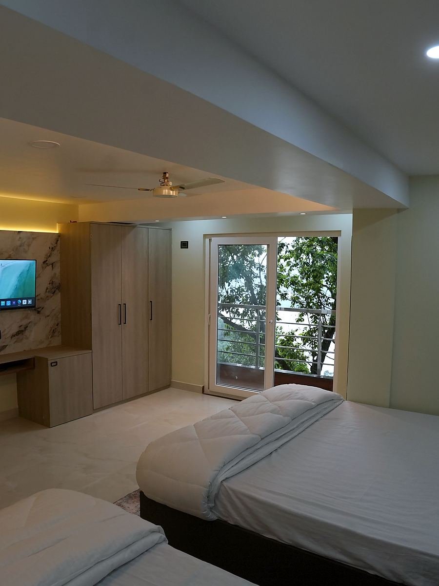 The non-air-conditioned Family Room, its beds beside the window and ceiling fan